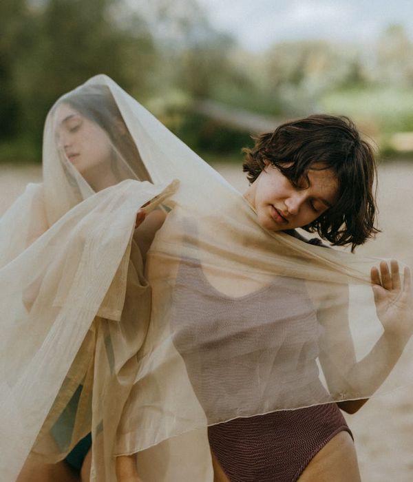 Woman performing a fluid, gentle cardio movement in a calm environment.